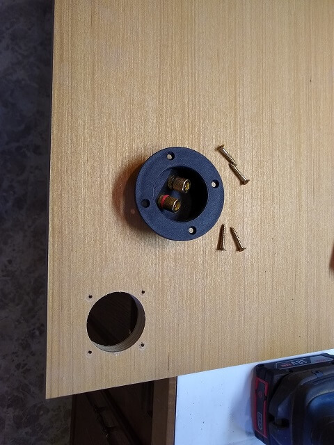 The hole drilled in the subwoofer top for the wire connection plate.