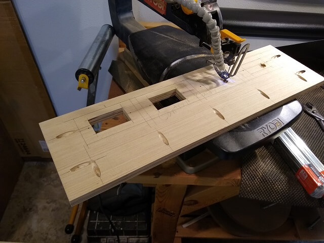 Cutting the holes for the RJ45 plates using a scroll saw.