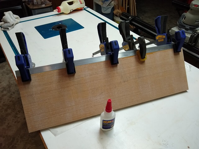 Gluing the aluminum L channel to the marquee top.