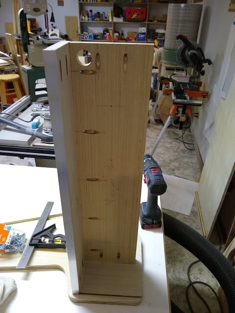 Attaching the marquee assembly to one side of the cabinet.