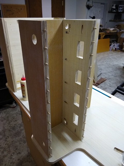 Attaching the control panel assembly to one side of the cabinet.
