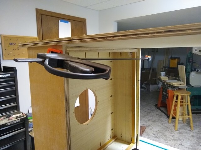 Attaching the other side of the cabinet to the subwoofer assembly.
