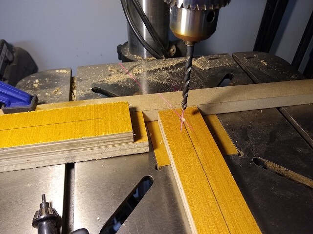 Drilling the holes for the dowels in the panel bottoms.