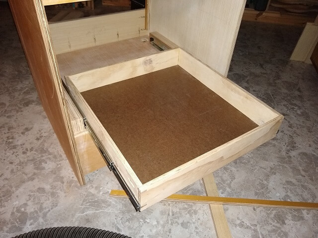 Test fitting a drawer with the slides and spacers.