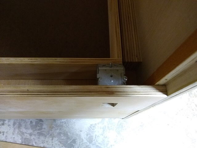 The electrical box preventing the drawer from sliding all the way back.