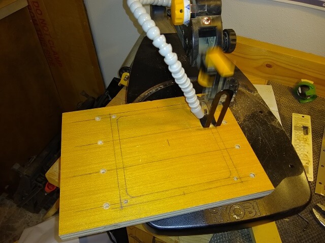 Cutting out the opening for the trackball using the scroll saw.