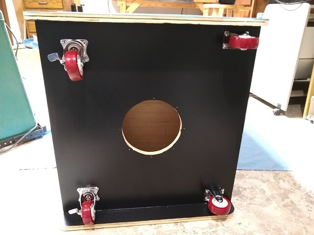 The painted bottom of the cabinet with the casters installed.
