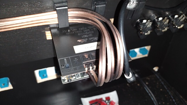 Audio wires connected to the back of the amplifier.