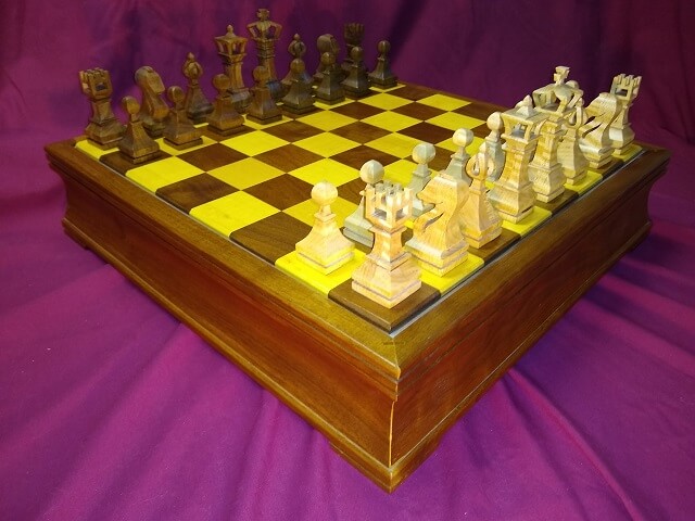 The completed chess pieces, sitting on the chess board I built.