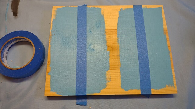 Applying blue painter's tape to define where the lines should be.