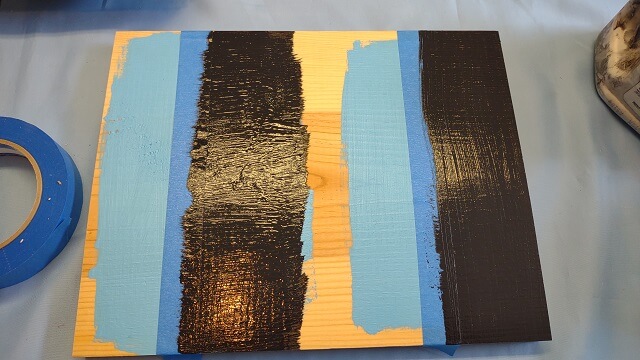 A coat of the darker color applied to both sections of the sample piece.
